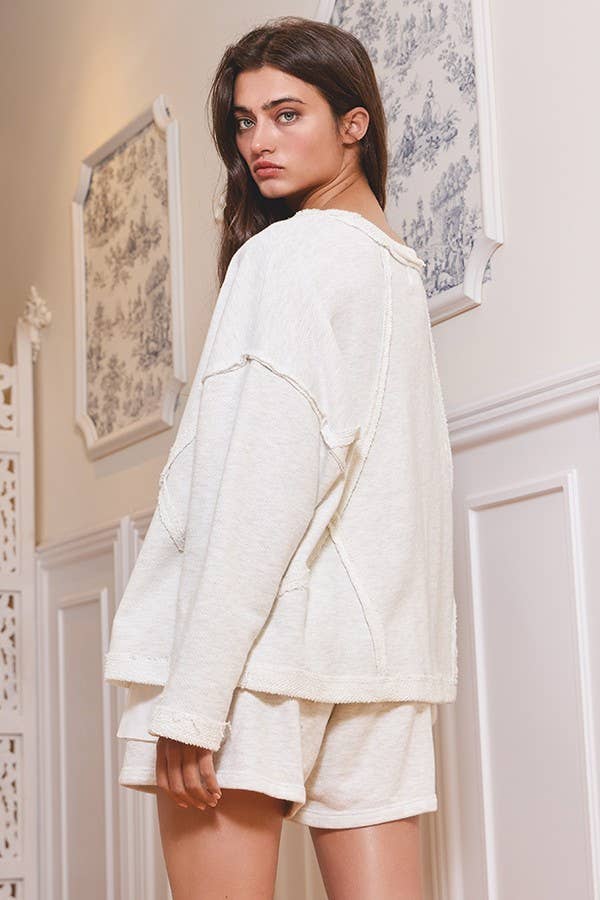 Back view of the Sunday Slowdown Top by Bucketlist in ash grey, showing its oversized fit and raw-edge seams