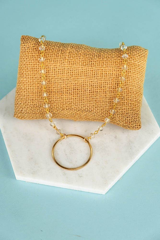 Circle pendant necklace with clear beads.
