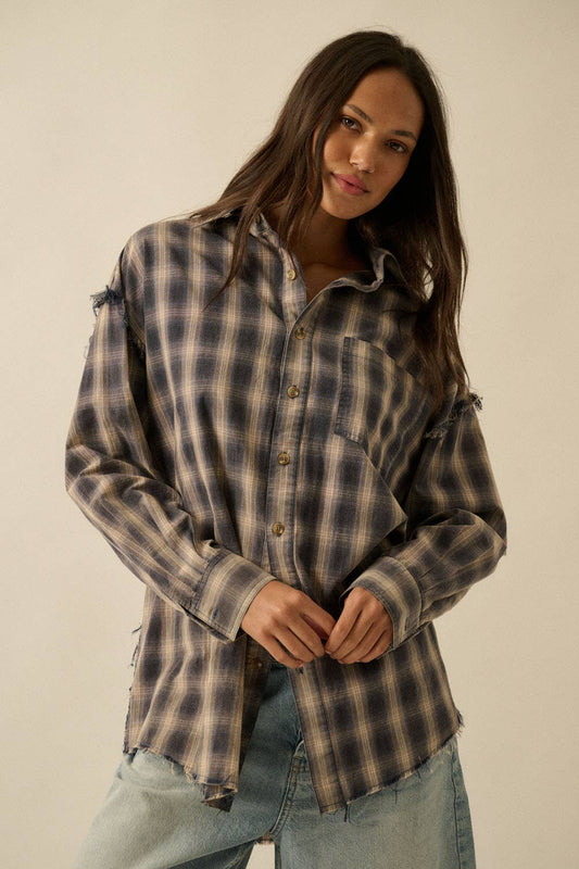 Woman wearing a plaid shirt and jeans against a plain background