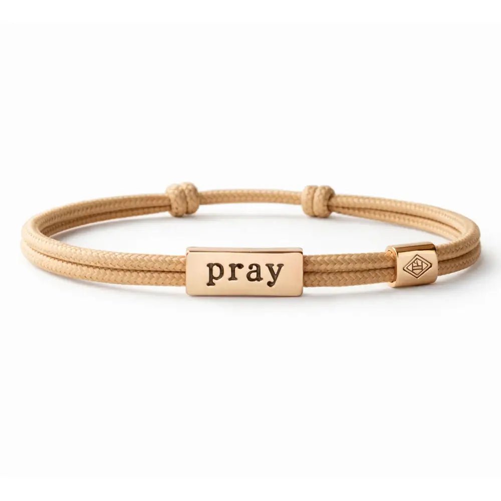 Beige bracelet with 'pray' tag on a white background
