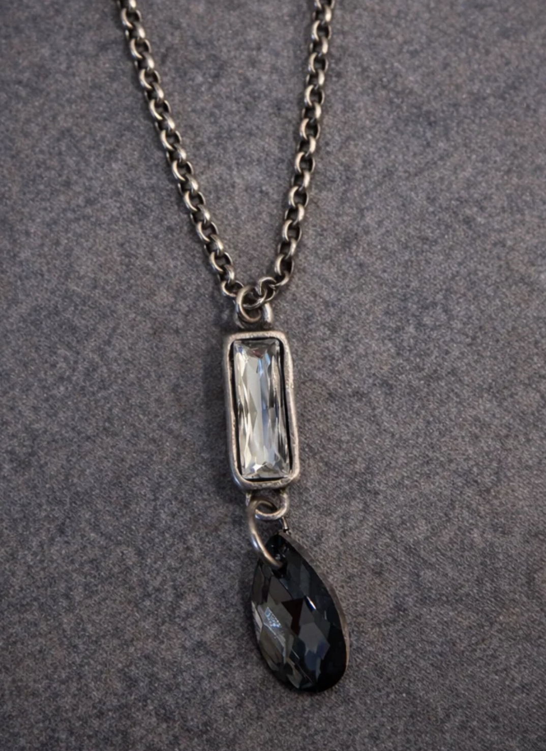 The Case Necklace with a silver-tone chain, clear baguette Austrian crystal and faceted black teardrop pendant