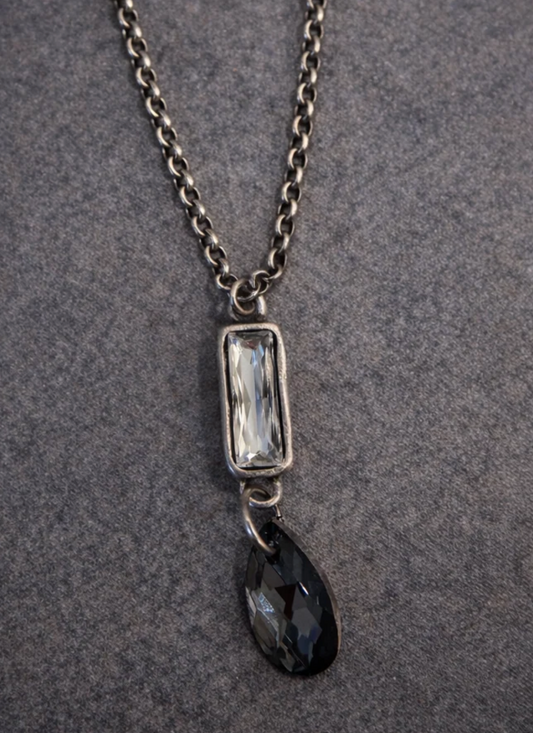 The Case Necklace with a silver-tone chain, clear baguette Austrian crystal and faceted black teardrop pendant