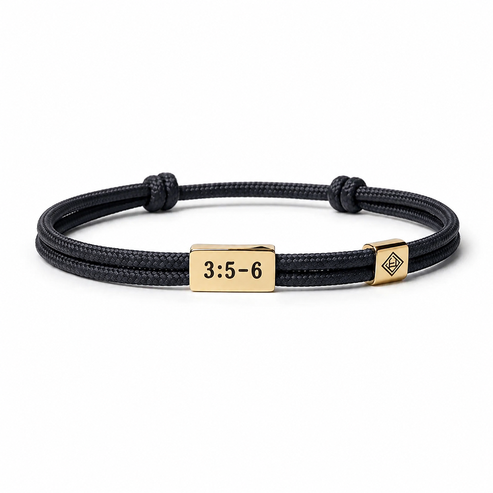 A black braided cord bracelet with a gold-plated rectangular plate engraved with '3:5-6' and a small geometric logo charm, shown on a white background.