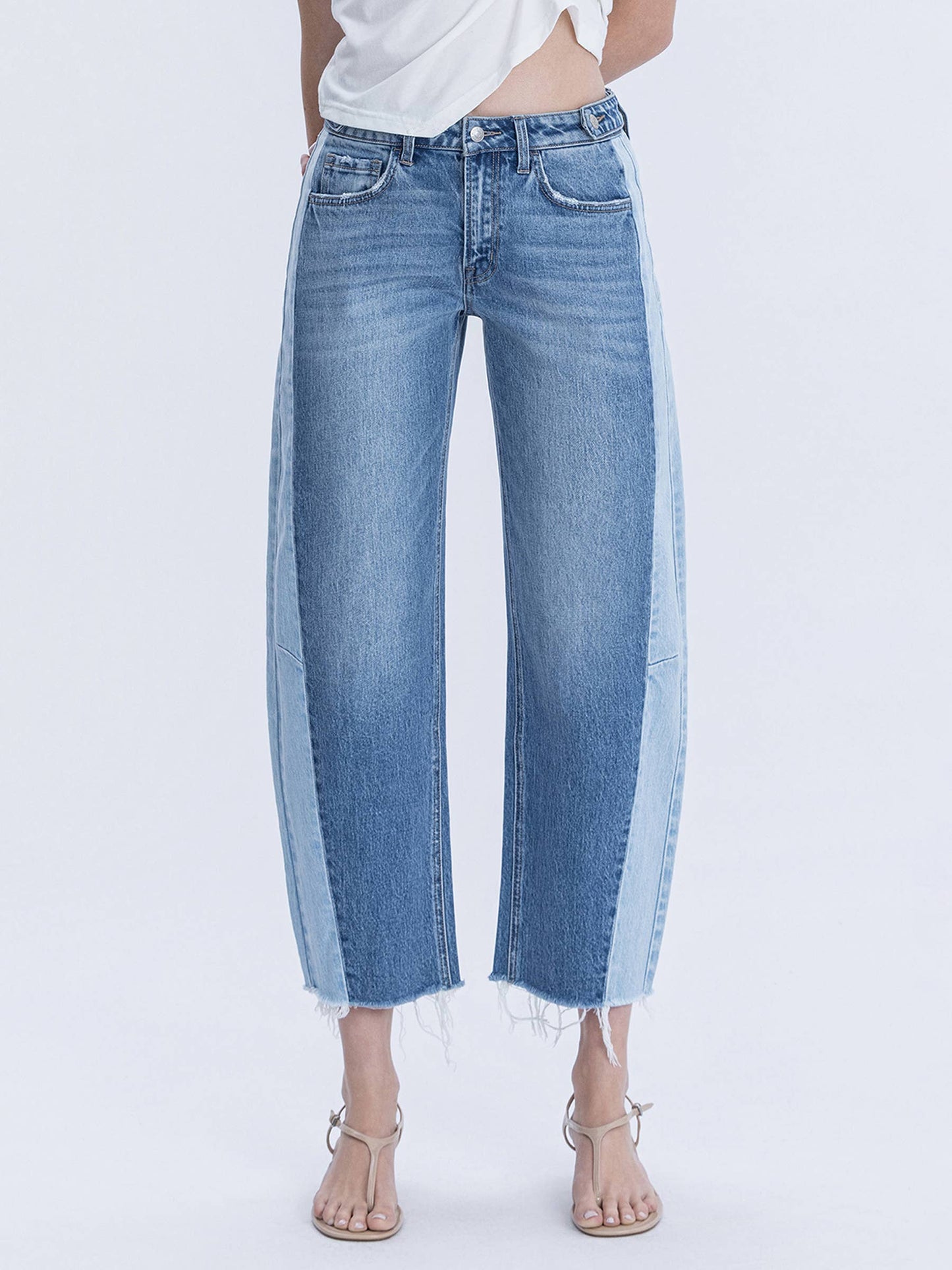 Two toned blue jeans with a white background.